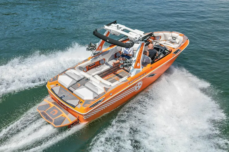 Slide: The Image of 2022 Centurion Ri245 boat cruising on water, vibrant orange design, aerial view. - 10