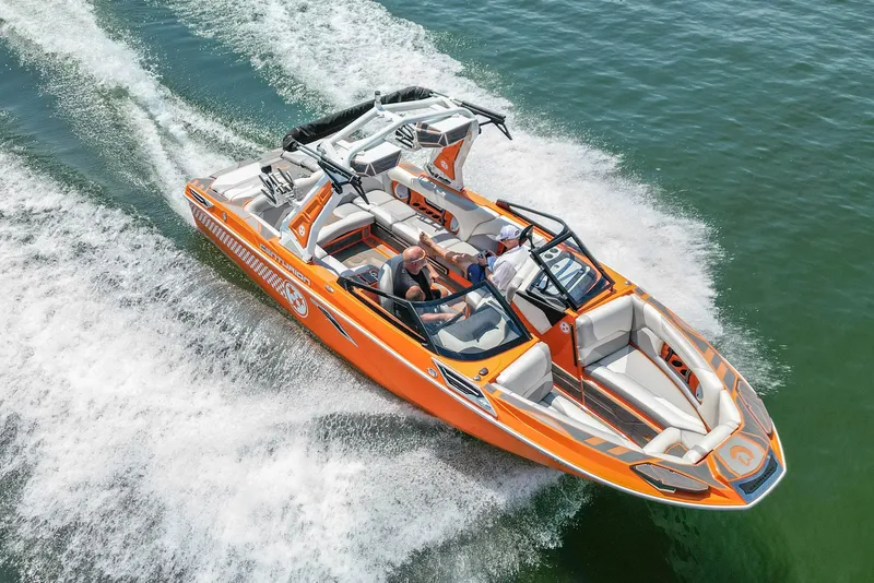Slide: The Image of 2022 Centurion Ri245 boat cruising on water, vibrant orange design, aerial view. - 11