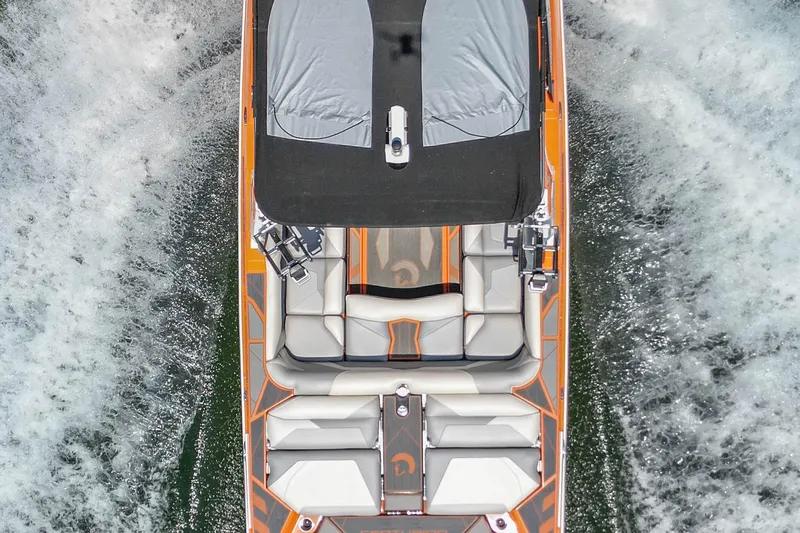 Slide: The Image of Aerial view of 2022 Centurion Ri245 boat on water, showcasing sleek design and seating. - 14