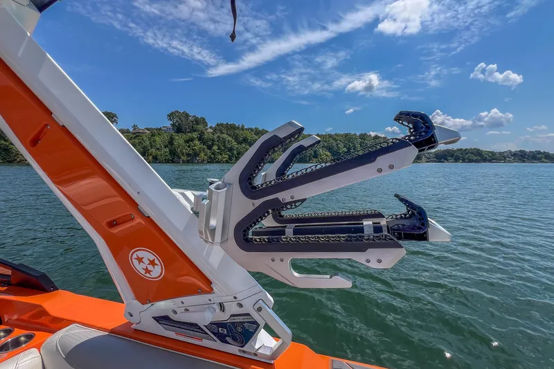 Slide: The Image of 2022 Centurion Ri245 boat with wakeboard rack on a sunny lake. - 27