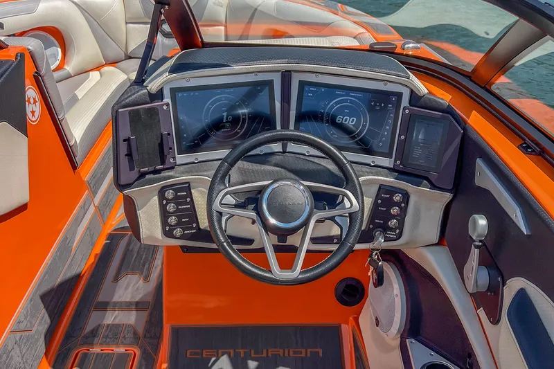 Slide: The Image of 2022 Centurion Ri245 boat dashboard with digital displays and steering wheel. - 29