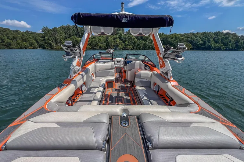 Slide: The Image of 2022 Centurion Ri245 boat interior on a lake, featuring spacious seating and modern design. - 33