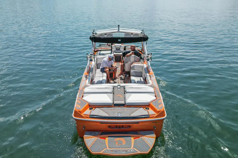 Slide: The Image of 2022 Centurion Ri245 boat cruising on a calm lake with passengers onboard. - 4