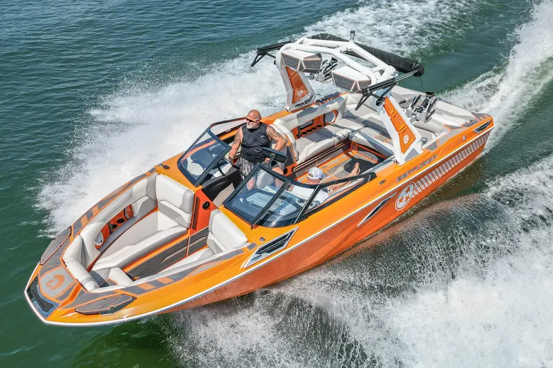 Slide: The Image of 2022 Centurion Ri245 boat cruising on water, vibrant orange design, sleek and modern. - 7