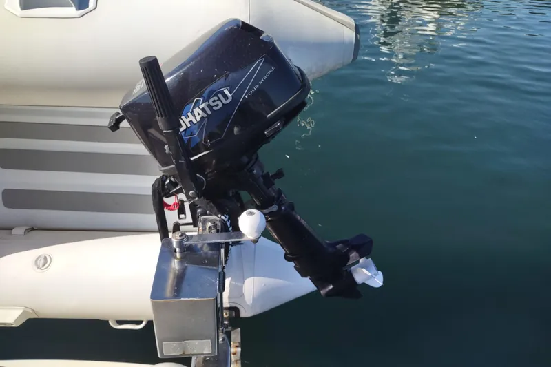 Slide: The Image of Outboard motor on a Camano Troll 2000 boat, floating on calm water. - 10