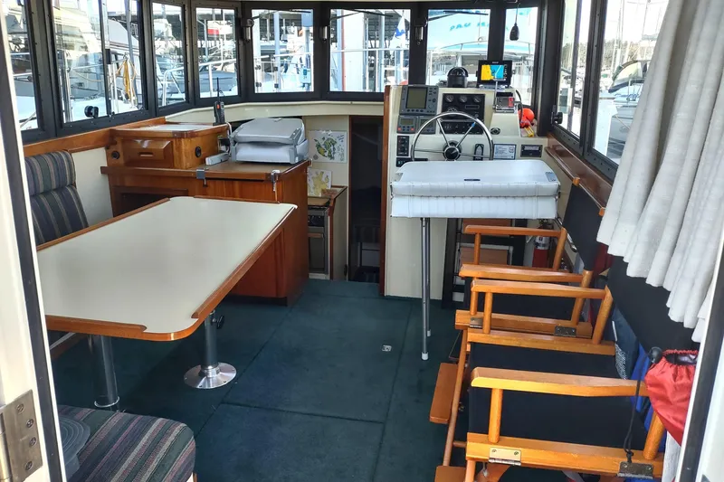 Slide: The Image of Interior of a 2000 Camano Troll boat with seating and navigation area. - 17