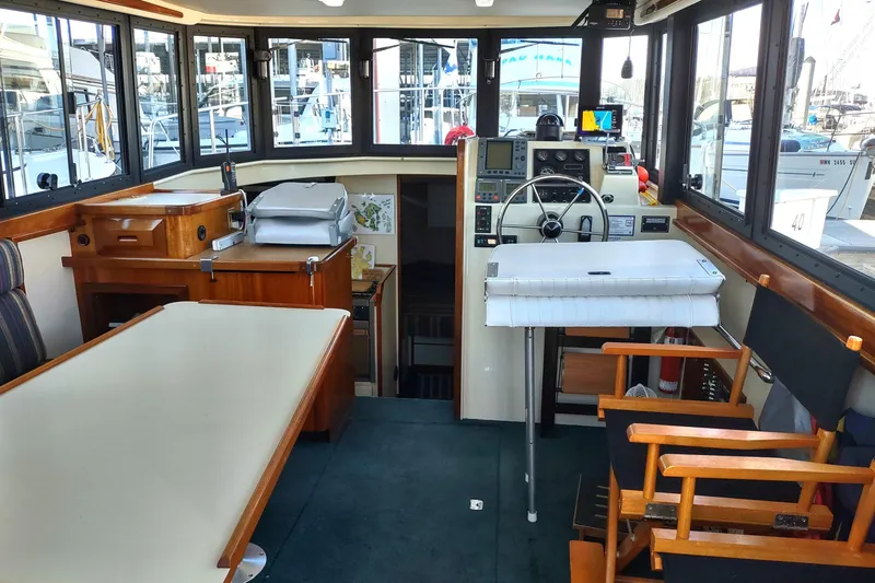 Slide: The Image of Interior of a 2000 Camano Troll boat with helm, seating, and navigation equipment. - 18