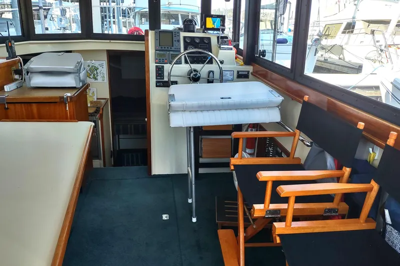 Slide: The Image of Interior of a 2000 Camano Troll boat with helm, seating, and navigation equipment. - 19