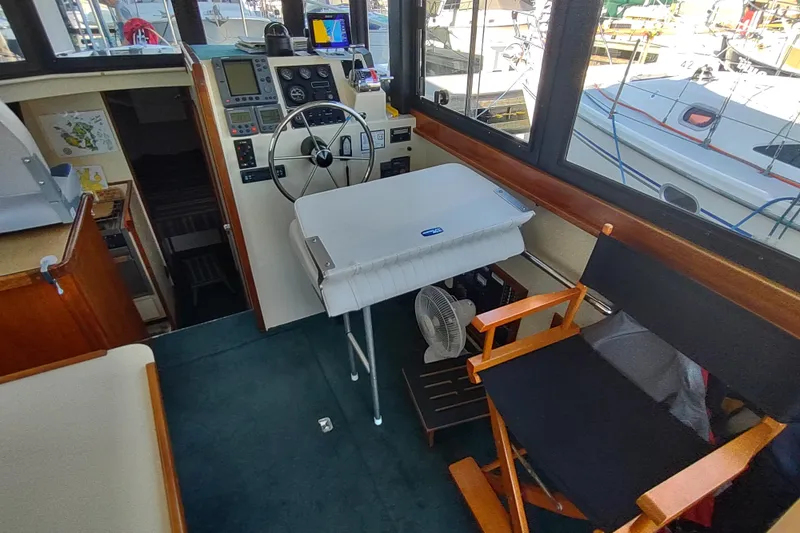 Slide: The Image of Interior of a 2000 Camano Troll boat with steering wheel and navigation equipment. - 20