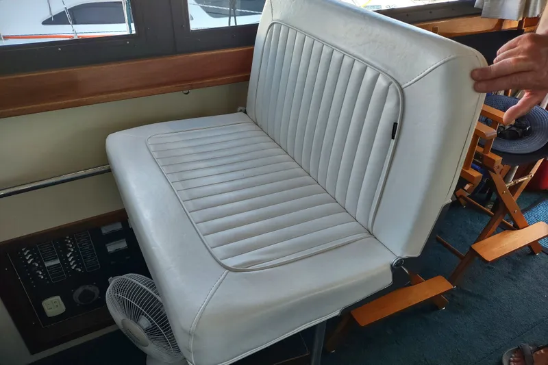 Slide: The Image of White leather seat in 2000 Camano Troll boat interior, near control panel and fan. - 21