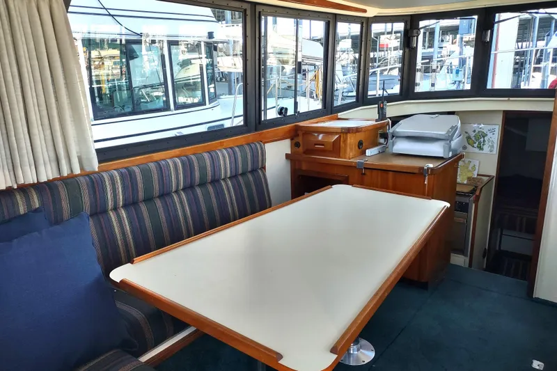 Slide: The Image of Interior of a 2000 Camano Troll boat with dining area and navigation equipment. - 23