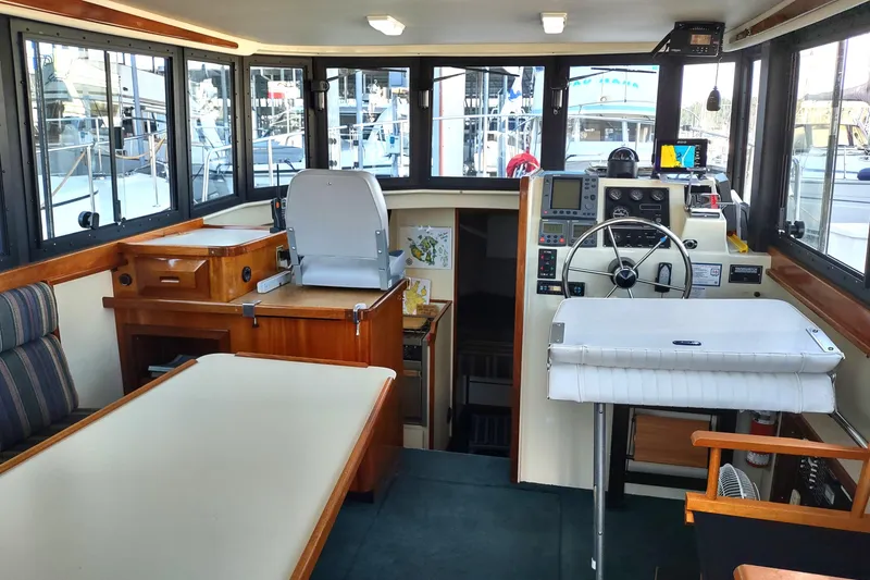 Slide: The Image of Interior of a 2000 Camano Troll boat with helm, seating, and navigation equipment. - 24
