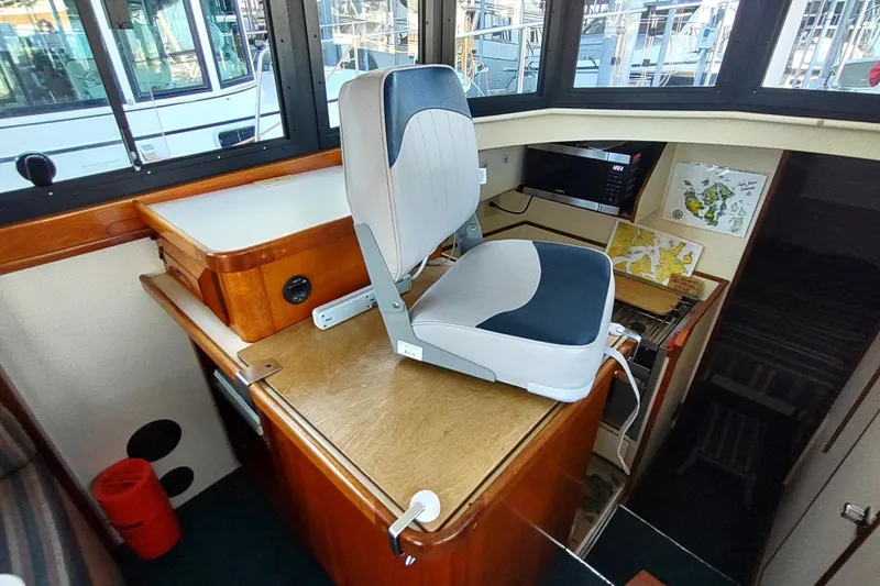 Slide: The Image of Interior of a 2000 Camano Troll boat with helm seat and navigation area. - 27