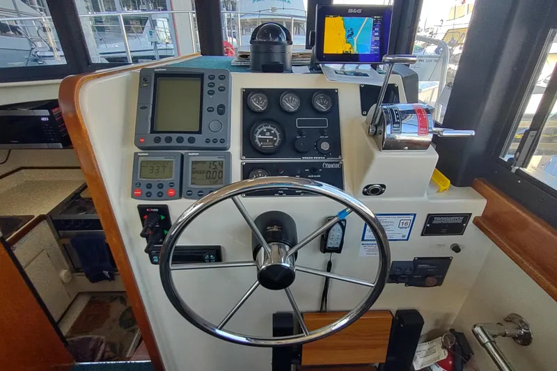 Slide: The Image of Control panel of a 2000 Camano Troll boat with navigation and steering equipment. - 28