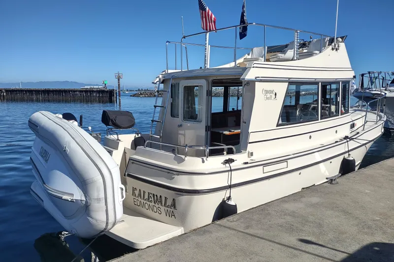 Slide: The Image of 2000 Camano Troll boat docked, featuring "Kalevala" and "Edmonds WA" on the stern. - 3