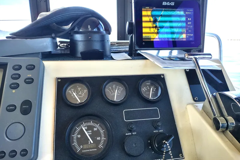 Slide: The Image of Control panel of a 2000 Camano Troll boat with navigation and engine gauges. - 32
