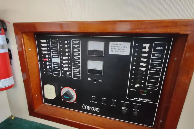 Slide: The Image of Electrical panel on a 2000 Camano Troll boat with various switches and gauges. - 35