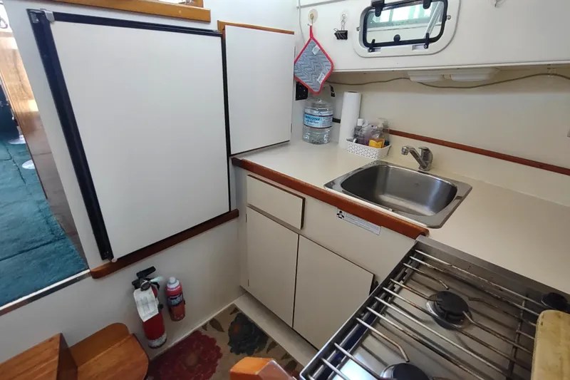 Slide: The Image of Compact kitchen in 2000 Camano Troll boat with sink, stove, and storage. - 38
