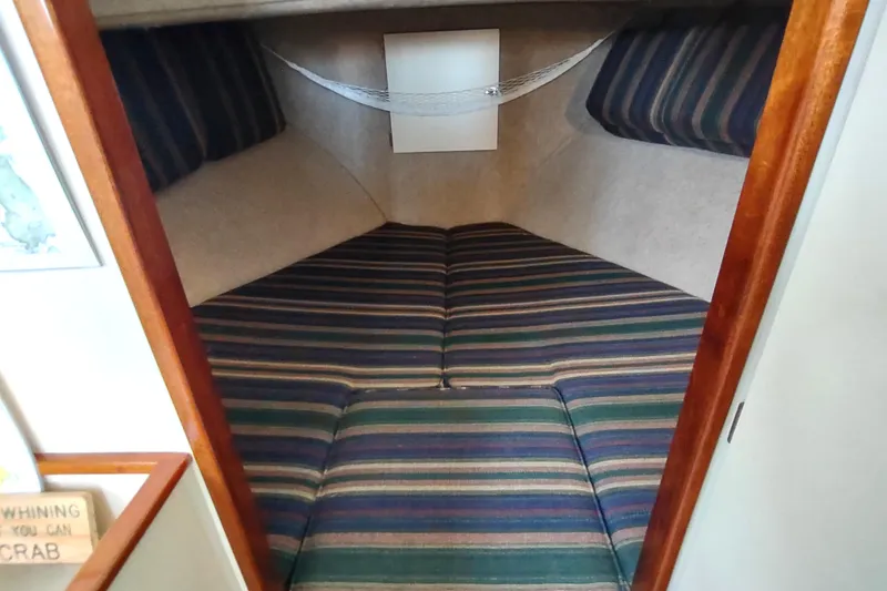 Slide: The Image of Cozy cabin interior of 2000 Camano Troll boat with striped cushions. - 39