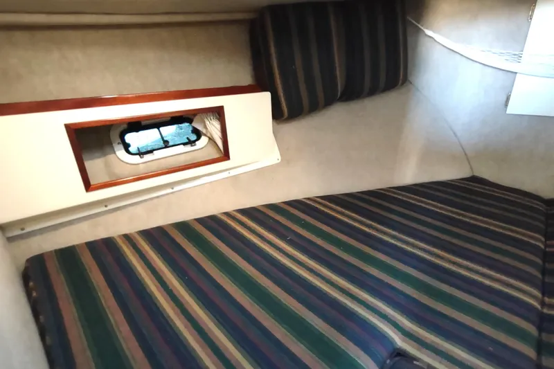 Slide: The Image of Interior cabin of a 2000 Camano Troll boat with striped upholstery. - 40