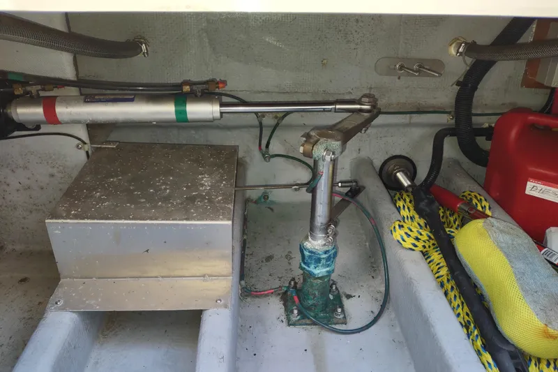 Slide: The Image of Engine compartment of a 2000 Camano Troll boat with mechanical components and ropes. - 45