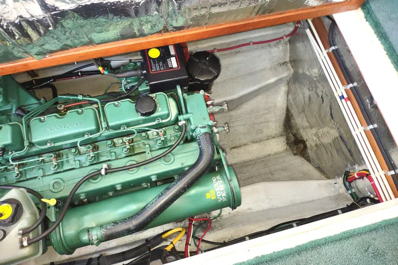Slide: The Image of Engine compartment of a 2000 Camano Troll boat featuring a Volvo Penta engine. - 47