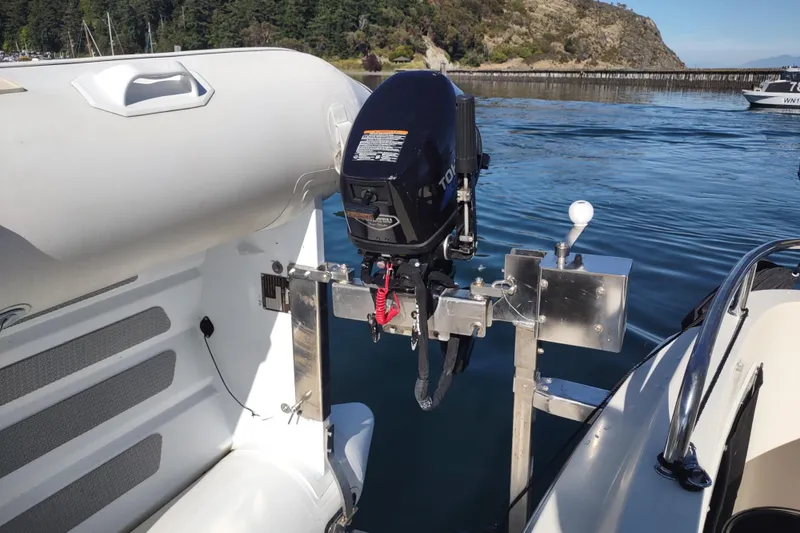 Slide: The Image of 2000 Camano Troll boat with outboard motor on calm water, scenic background. - 6