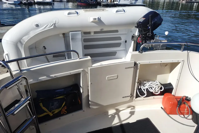Slide: The Image of 2000 Camano Troll boat interior with storage compartments and outboard motor. - 7