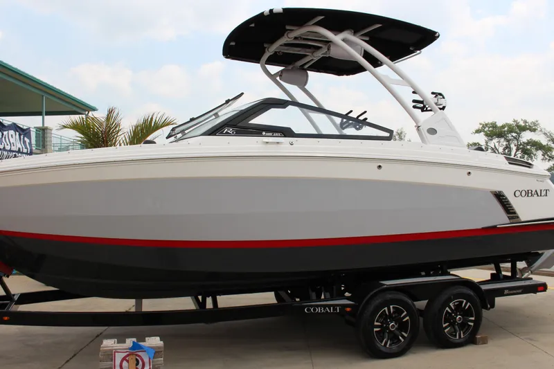 The Image of 2024 Cobalt R6 Surf boat on trailer, featuring sleek design and modern features. - 0