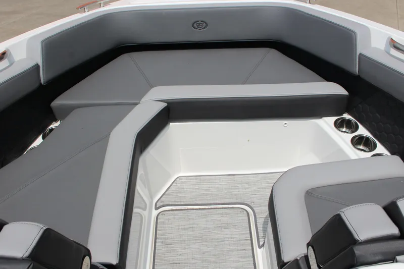 Slide: The Image of 2024 Cobalt R6 Surf boat interior with gray seating and cup holders. - 10