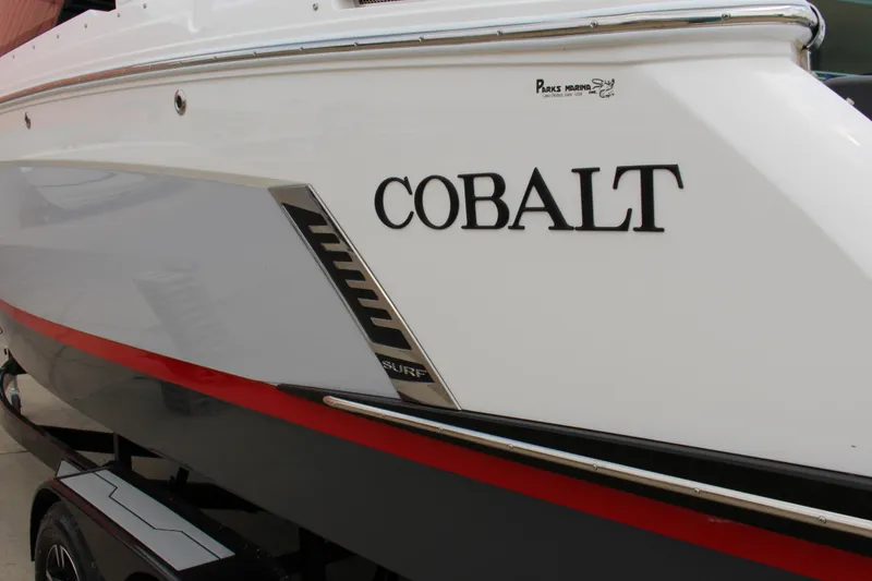 Slide: The Image of 2024 Cobalt R6 Surf boat with sleek design and branding details. - 2