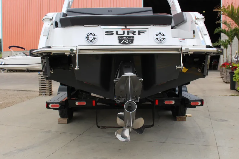 Slide: The Image of 2024 Cobalt R6 Surf boat rear view on trailer, showcasing propeller and design. - 3