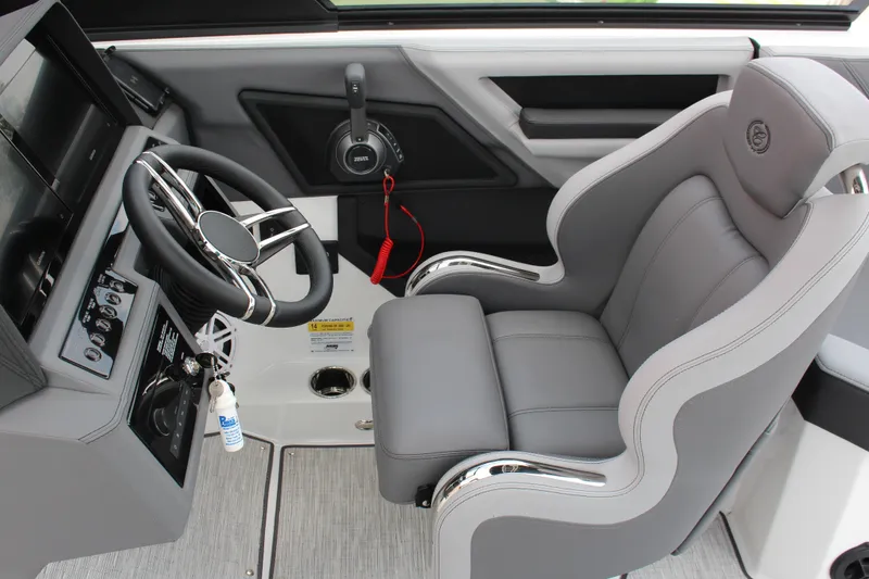 Slide: The Image of 2024 Cobalt R6 Surf boat cockpit with sleek steering wheel and luxurious gray seating. - 7