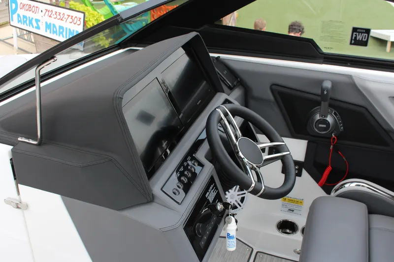 Slide: The Image of 2024 Cobalt R6 Surf boat dashboard with steering wheel and control panel. - 8