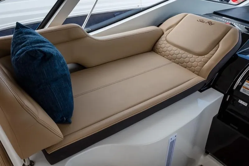 Slide: The Image of Manufacturer Provided Image: 2019 Sea Ray Sundancer 350 Coupe interior lounge with tan leather seating and blue pillow. - 22
