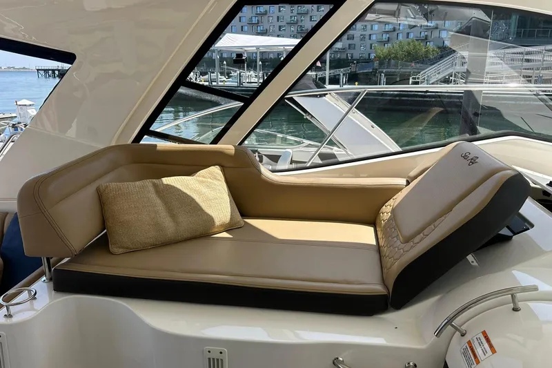 Slide: The Image of Luxurious seating on 2019 Sea Ray Sundancer 350 Coupe yacht, docked with waterfront view. - 5