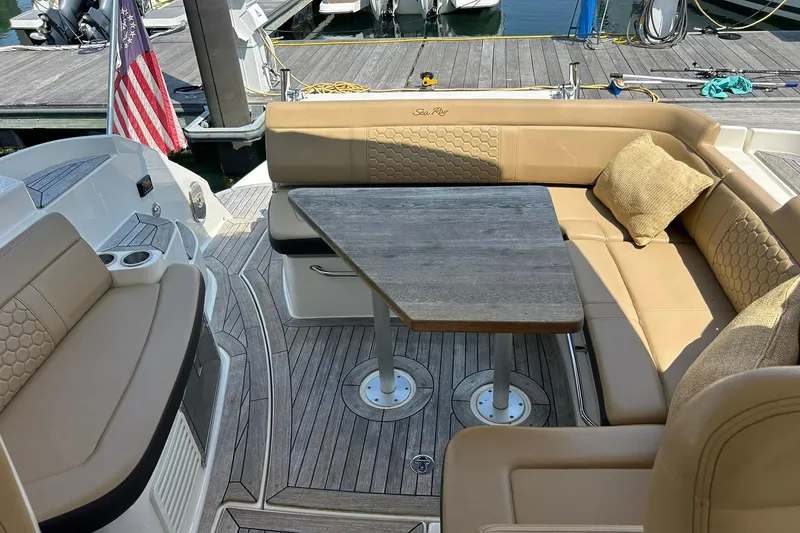 Slide: The Image of 2019 Sea Ray Sundancer 350 Coupe with elegant seating and table on deck. - 6