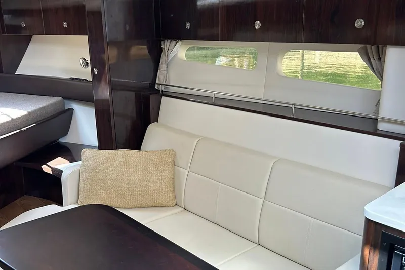Slide: The Image of Luxurious interior of 2019 Sea Ray Sundancer 350 Coupe with elegant seating and wood finishes. - 9