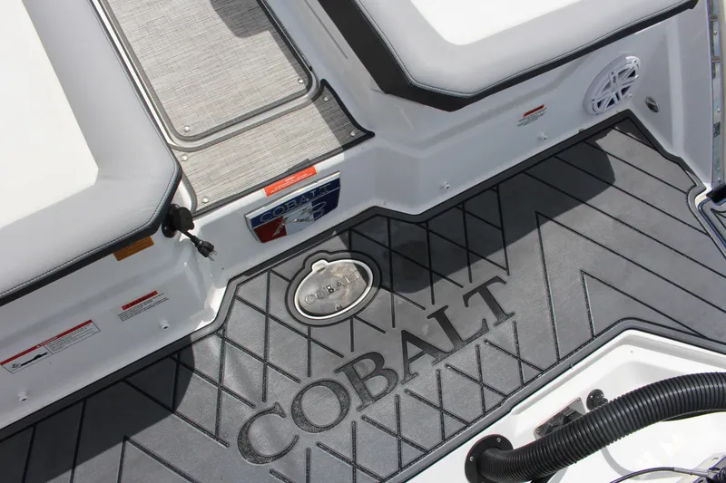 Slide: The Image of 2024 Cobalt R8 Outboard boat deck with logo and seating area. - 10