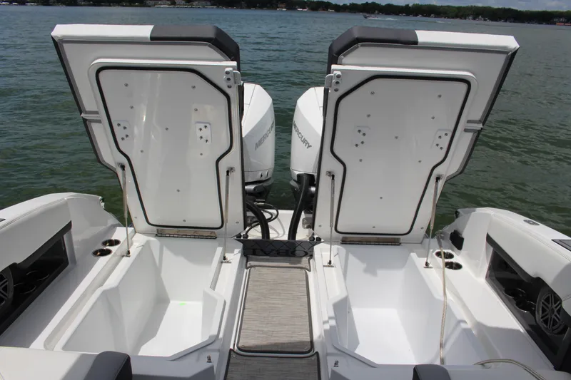 Slide: The Image of 2024 Cobalt R8 Outboard boat with open storage compartments on a lake. - 11