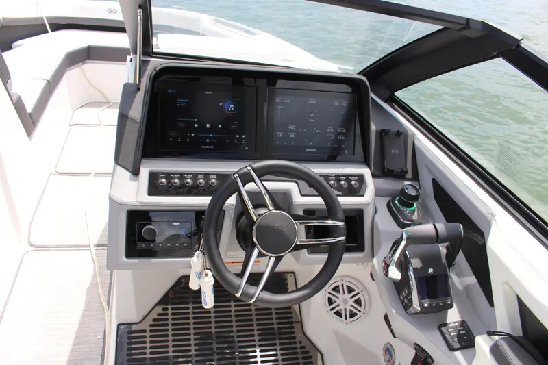 Slide: The Image of 2024 Cobalt R8 Outboard boat cockpit with modern steering and digital controls. - 4