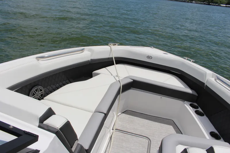 Slide: The Image of 2024 Cobalt R8 Outboard boat interior with luxurious seating on a calm lake. - 6