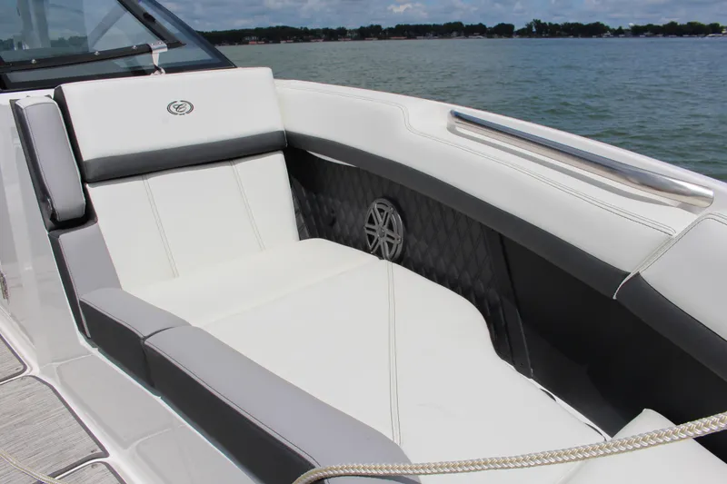 Slide: The Image of 2024 Cobalt R8 Outboard boat interior with luxurious white seating and lake view. - 7