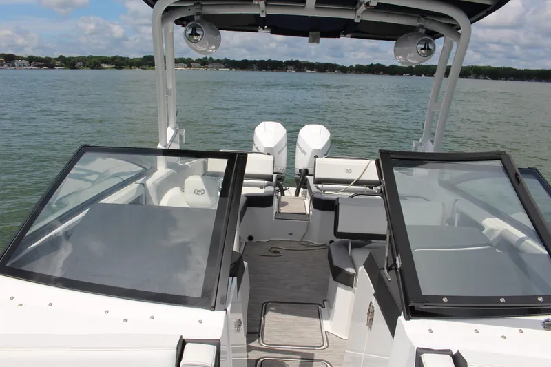 Slide: The Image of 2024 Cobalt R8 Outboard boat interior with dual engines on a lake. - 8