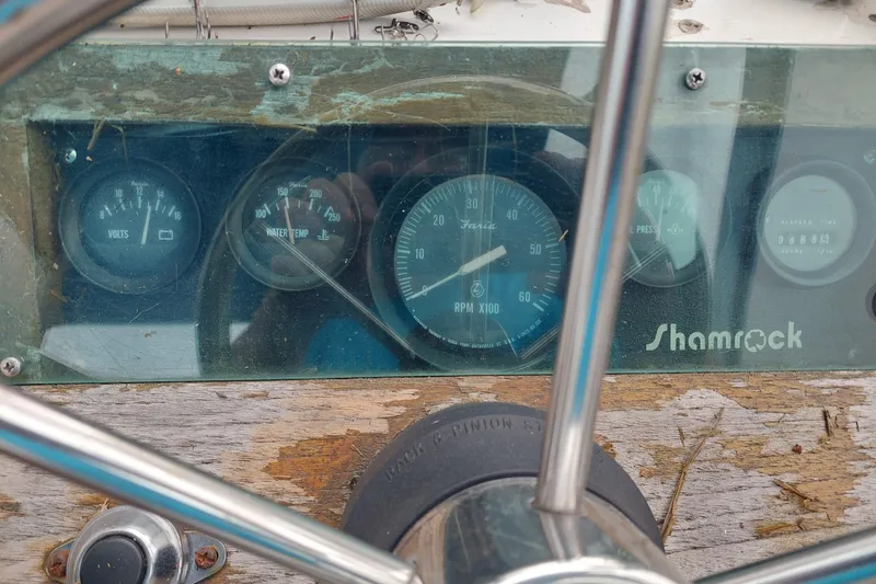 Slide: The Image of 1986 Shamrock 20 Walk Through boat dashboard with gauges and steering wheel. - 6
