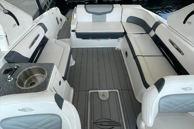 Slide: The Image of 2020 Chaparral 297 SSX boat interior with white and gray seating. - 10