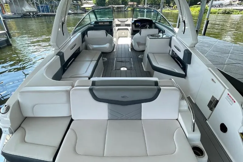 Slide: The Image of 2020 Chaparral 297 SSX boat bathroom with sink, toilet, and porthole window. - 5