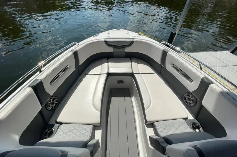 Slide: The Image of 2020 Chaparral 297 SSX boat interior with luxurious seating and sleek dashboard design. - 7