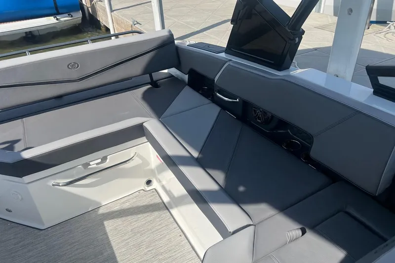 Slide: The Image of 2024 Cobalt R6 Surf boat interior with sleek gray seating and modern design. - 6
