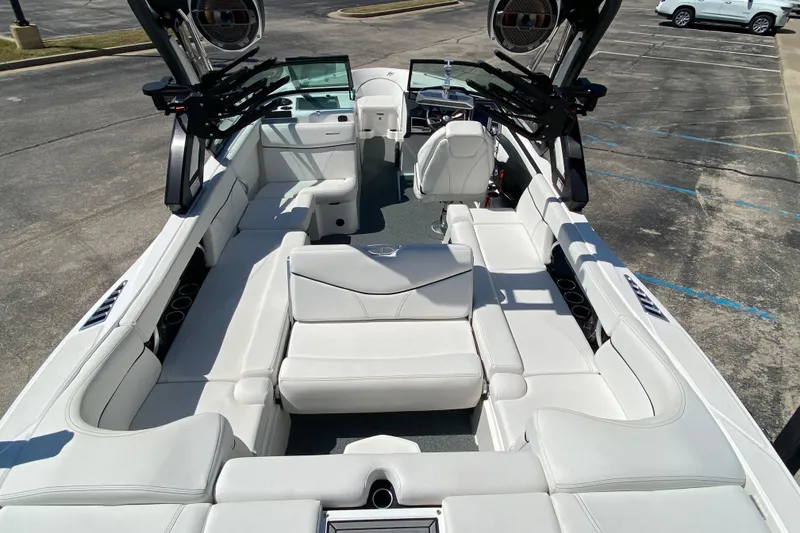 Slide: The Image of 2022 MasterCraft XT25 boat interior with luxurious white seating and modern design. - 10